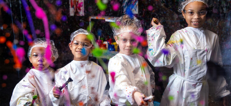 Kids painting on glass wall at Pinspiration