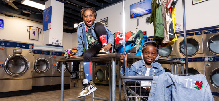 Twins Channing and Kingston styled photo at a laundromat.