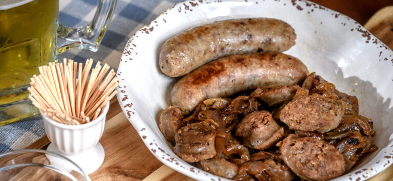plate of brats links and sliced with toothpicks on the side