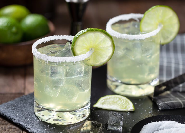 Margarita cocktail with ice, lime and salt riim