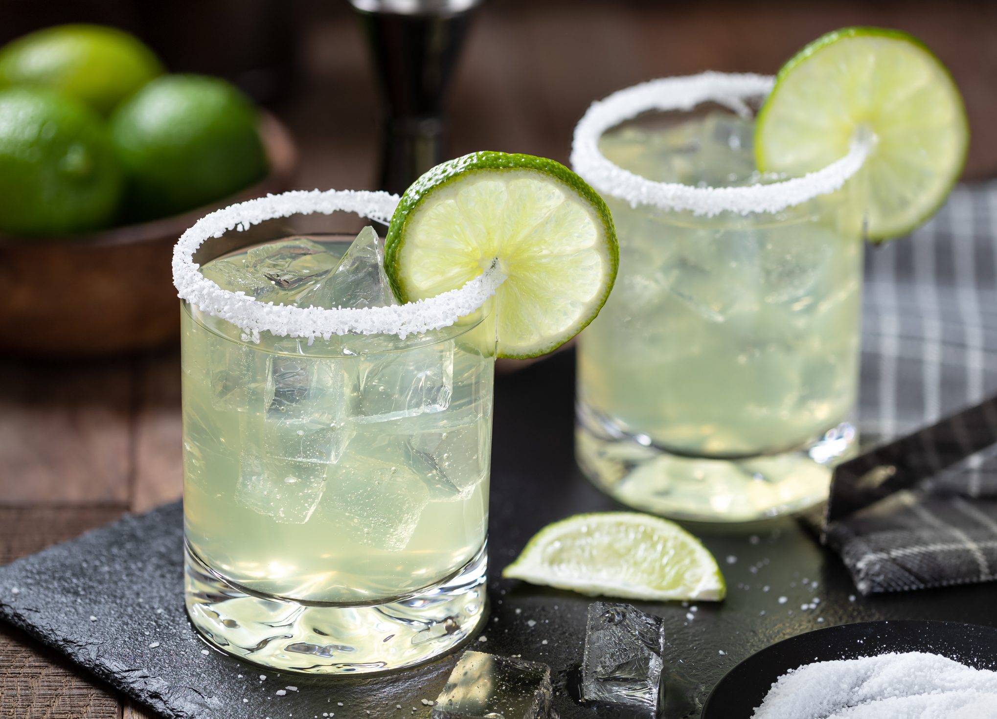 Margarita cocktail with ice, lime and salt riim